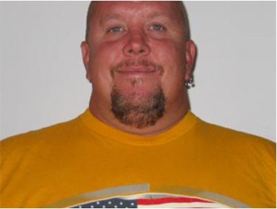 Scott Perzentka before the accident, smiling, wearing a yellow T-shirt